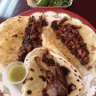 Three tacos: asada, pastor, and carnitas.  You add your own salsa, etc from the salsa and condiment bar.