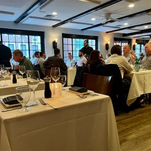 people sitting at tables in a restaurant