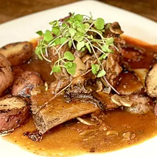 a plate of meat and potatoes