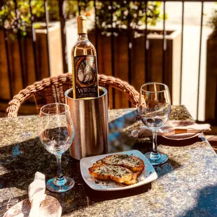 a bottle of wine and a plate of food