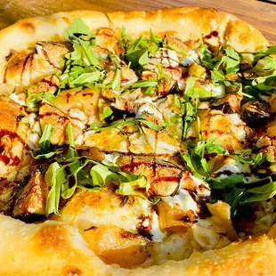 PIZZA FICHE&apos;    WHITE PIZZA, FRESH FIGS, CARAMELIZED ONIONS, GOAT CHEESE, MOZZARELLA, FRESH ROSEMARY, BALSAMIC REDUCTION, FRESH ARUGULA