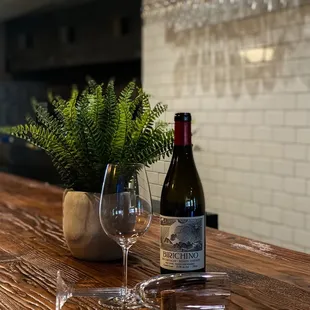 a bottle of wine and a glass of wine