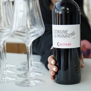 a woman holding a bottle of wine