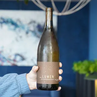 a person holding a bottle of wine