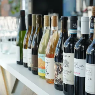 a row of wine bottles on a bar
