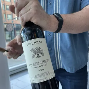 a man holding a bottle of wine