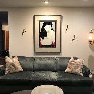 Patrick Nagel framed in double mat with spacer and soft gray silver stripe highlighted lacquer frame. 28"X64."