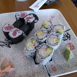 a plate of sushi and a glass of water