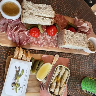 Charcuterie Board (top), sardines in a can (bottom)