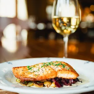 a plate of food and a glass of wine