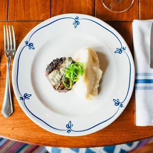 a plate of food on a wooden table