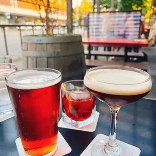 two glasses of wine and a drink on a table