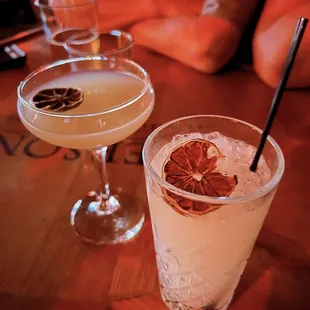 two cocktails on a wooden table