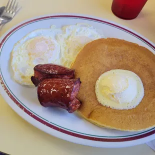 2 eggs over easy, 2 pancakes dollop of butter, smoked sausage