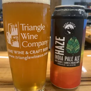 a pint glass and a can of triangle wine