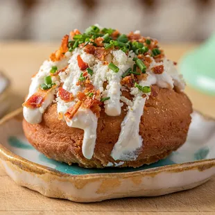 a close up of a baked potato on a plate