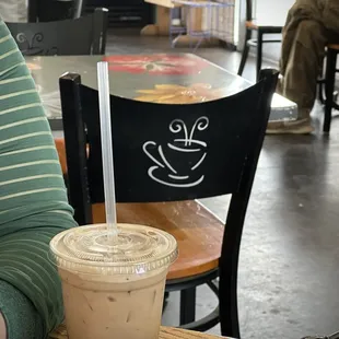 a person sitting at a table with a cup of coffee