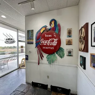 a large coca cola sign on the wall