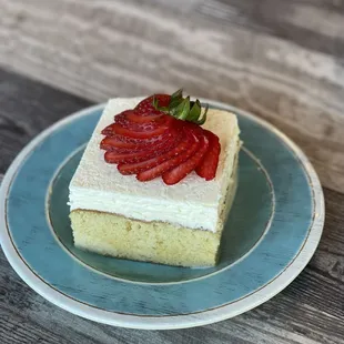 a piece of cake with strawberries on top