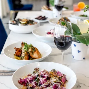 plates of food and a glass of wine