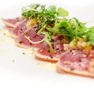 a piece of tuna on a white plate