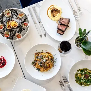 a variety of plates of food on a table