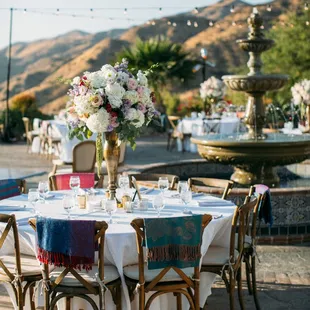 Tricia and Kanika put shawls down for all the tables that had women and girls. Photo Cred: @scottclarkphoto Flowers: Unique Floral Designs