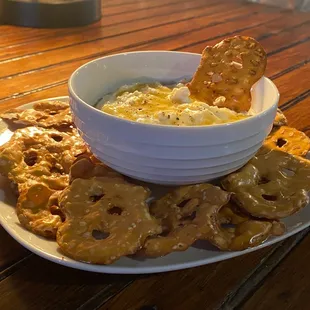 a bowl of dip and crackers