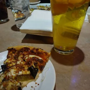 The perfect slice of pizza and refreshing beer to sip on.