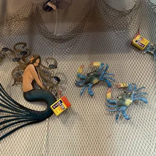 a mermaid, crab, and crab net