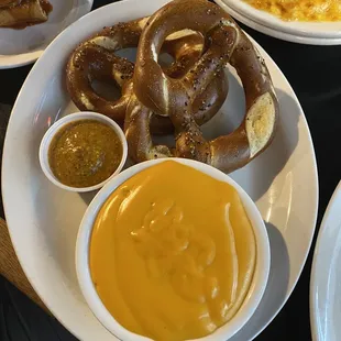 Baked pretzels with pepper, cheese sauce and spicy mustard