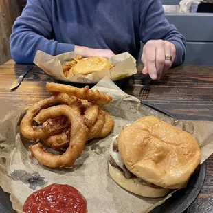 My Mushroom &amp; Swiss Burger with onion rings in the foreground. My husband had a burger with a bunch of jalapenos.