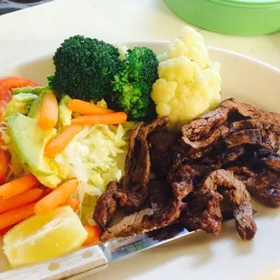 a plate of meat, vegetables, and rice