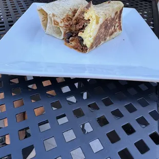 a burrito on a plate on a table