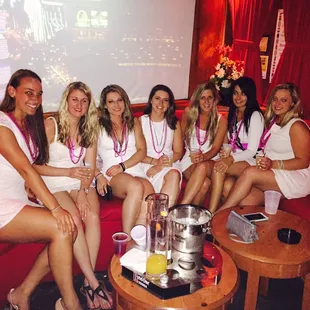 a group of women in white dresses