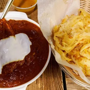 Spicy curried pompano fish dish and Kerala style paratha