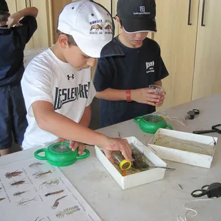 Boys examine the thing they found in the pond.