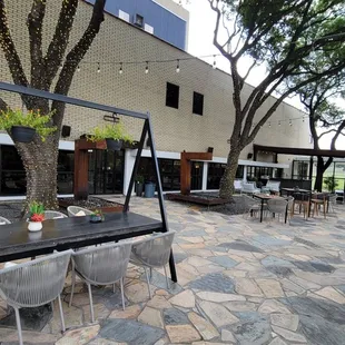 a patio with tables and chairs