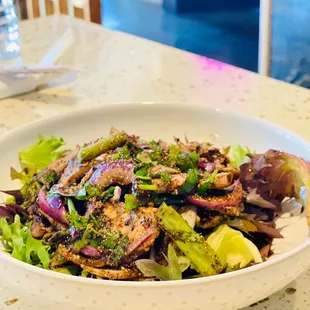 a bowl of salad on a table