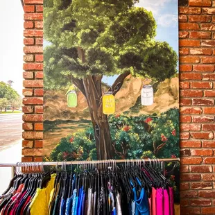 Entrance with clothing rack and artwork of founding of store