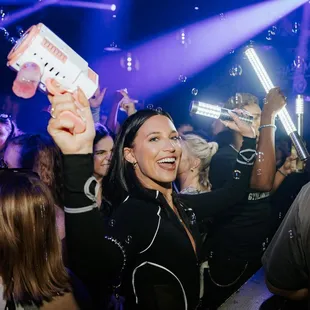 a woman holding up a bottle of booze