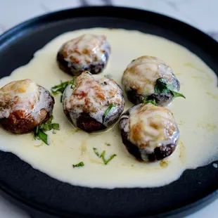 Papa&apos;s Mushrooms - 
Mushroom caps filled with veal, breadcrumbs, topped with Fontina cheese and finished with lemon-butter basil sauce