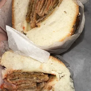 a person holding a sandwich in their hand