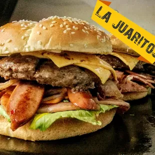 a hamburger with bacon, cheese, and lettuce