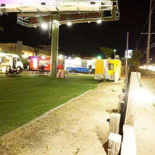food trucks parked in a parking lot at night