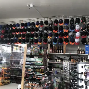 a variety of sports hats hanging from the ceiling