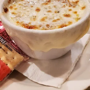 a cup of soup and crackers