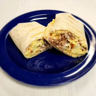 a breakfast burrito on a blue plate