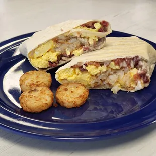 a breakfast burrito on a blue plate