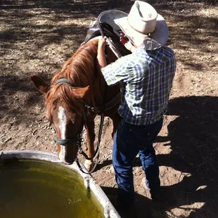 Dominic, one of the guides, preps a horse for a guest.
